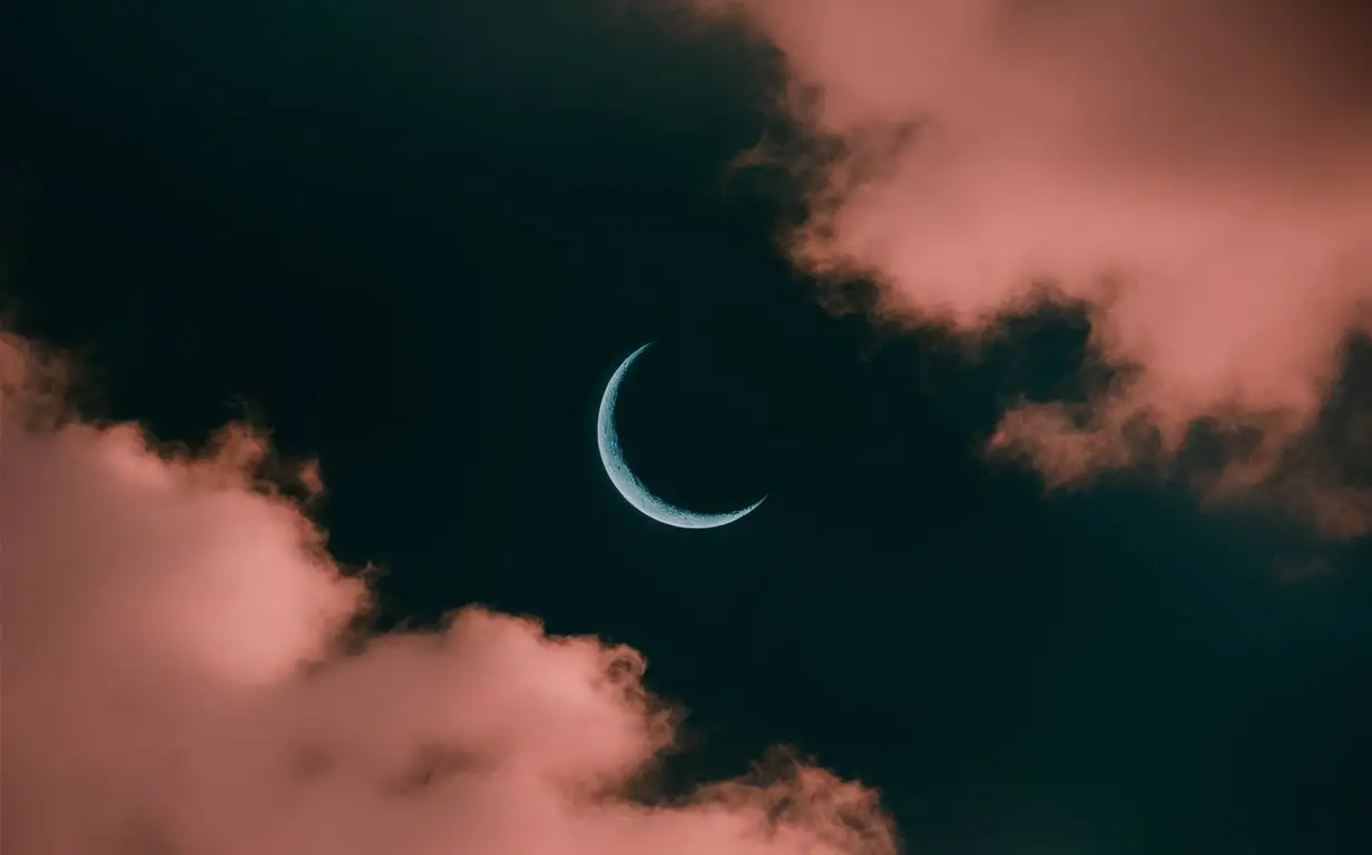 dark cyan sky with crescent moon and golden pink clouds