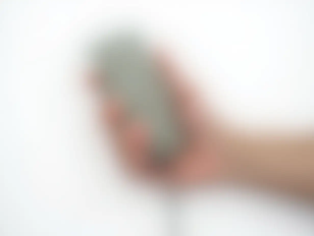 CloseUp-of-a-Mans-Hand-Holding-an-OldFashioned-Mobile-Phone