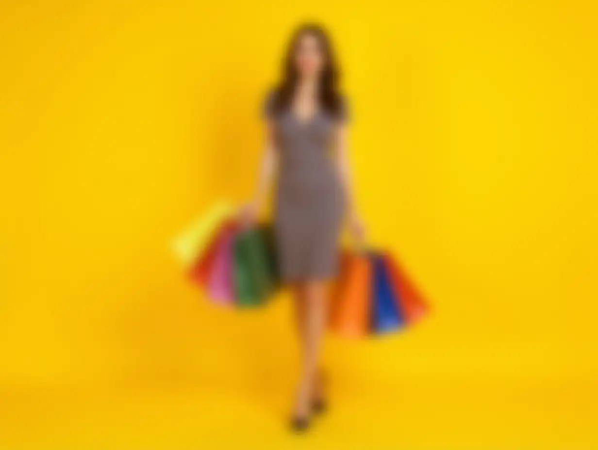 Full-length image of woman in elegant dress and heels holding many colorful shopping bags against yellow studio background. Concept of Black Friday, Cyber Monday, shopping, sales