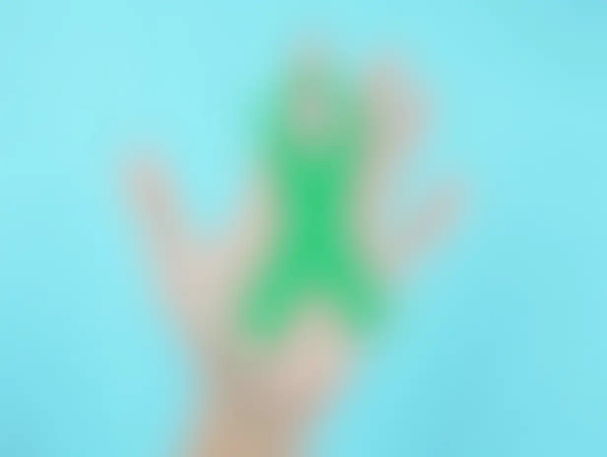 Hand-Holding-Green-Ribbon-on-Light-Blue-Background-Liver-Cancer-Awareness