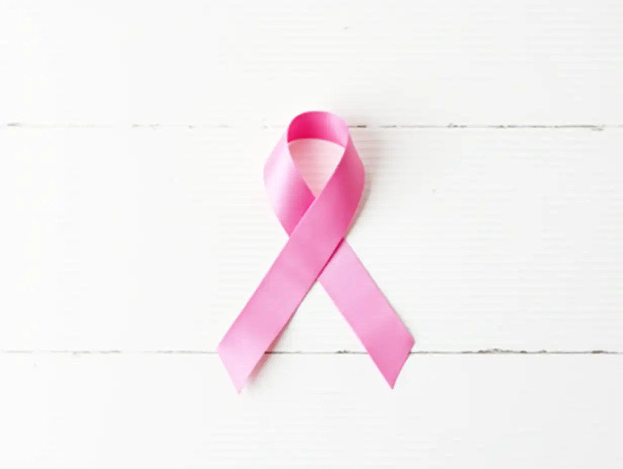 Breast-Cancer-Awareness-Satin-Pink-Ribbon-on-White-Wood-Background