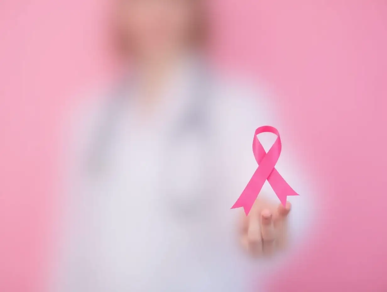 Doctor-Using-Pink-Ribbon-for-Breast-Cancer-Awareness-on-Pink-Background