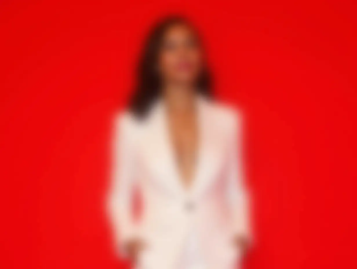 Confident Woman in Stylish White Suit on Red Background