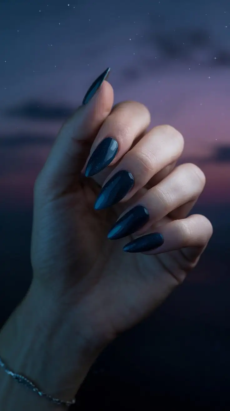 CloseUp-of-Womans-Hand-with-Stiletto-Nails-and-Twilight-Blue-Polish-Against-a-Starry-Sky