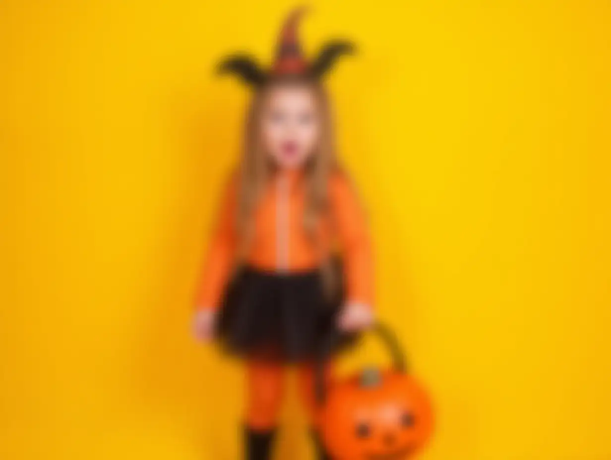 Adorable-Toddler-in-Halloween-Outfit-Holding-a-Pumpkin-Candy-Bucket