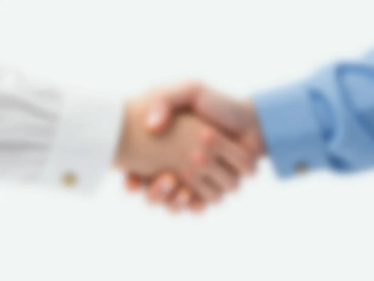 Close-up of two hands shaking, one in white and the other in blue shirt, on a white background. Concept of agreement, partnership, and business collaboration