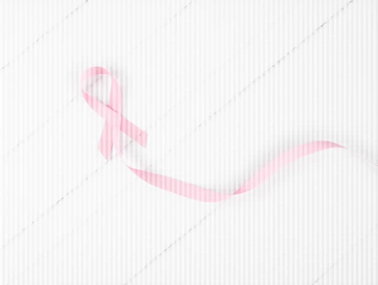 Breast-Cancer-Awareness-Pink-Ribbon-on-White-Wooden-Background