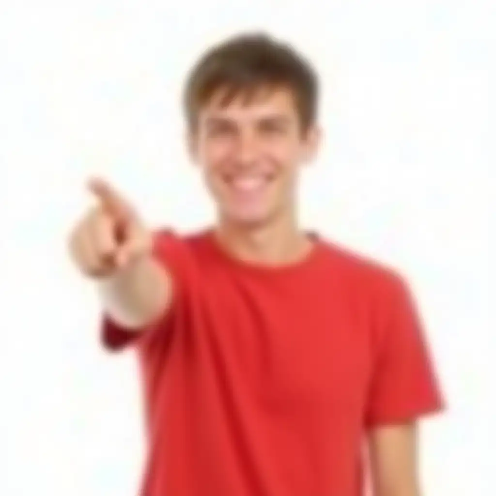 A young man with short brown hair is smiling broadly, pointing confidently to his left with his right hand. He is wearing a plain red shirt, completely free of stripes or patterns. His posture is relaxed and approachable, with an air of positivity and enthusiasm. Any visible marks on his left arm should be omitted. The background is white and minimal, ensuring that the focus remains entirely on him and his cheerful gesture.